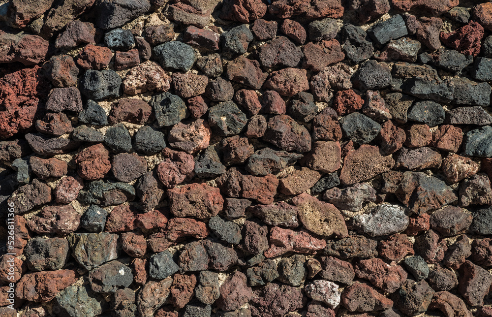 Wall built of lava remains or igneous rocks. Close-up. Wall built of lava remains or igneous rocks. Close-up.