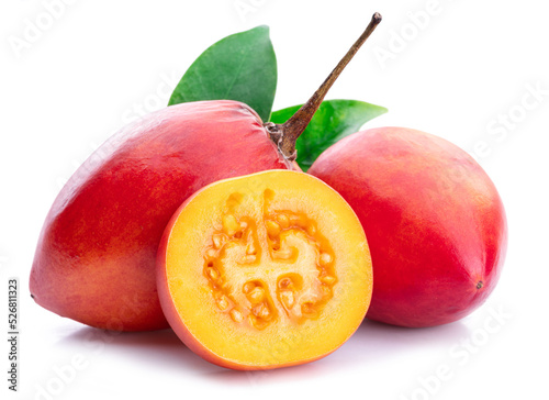 Fototapeta Naklejka Na Ścianę i Meble -  Ripe tamarillo fruits with slices and tamarillo leaves isolated on a white background.