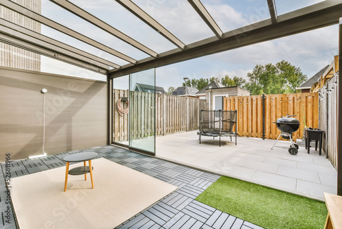 Εκτύπωση καμβά Neat paved patio with sitting area and small garden near wooden fence