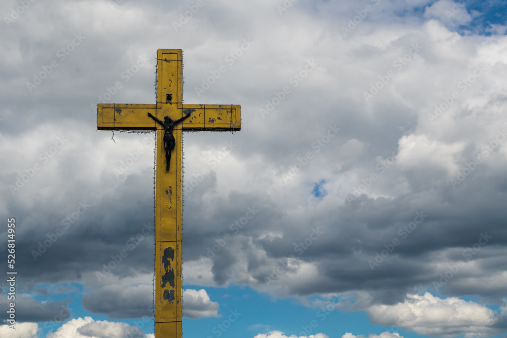 Big cross on cloudy background with free space for text