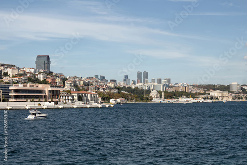 View of a yacht on Bosphorus and European side of Istanbul. It is a sunny summer day.