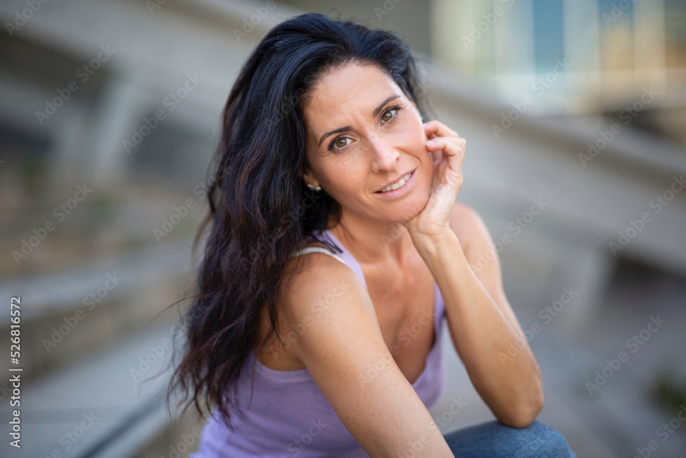 Smiling caucasian woman with her hand on chin