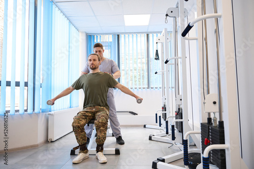 Instructor helps soldier recover from injury in military hospital