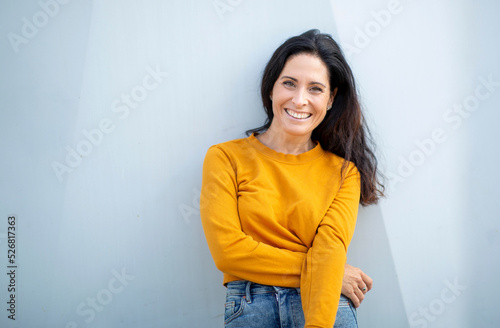 Portrait of smiling woman posing outdoors in city photo
