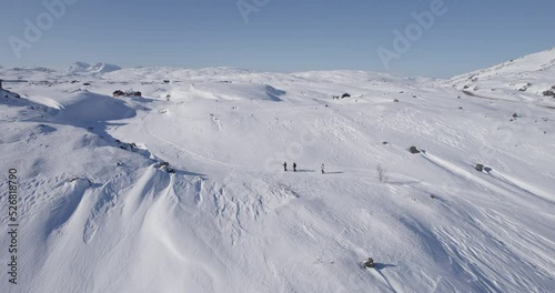 People hiking in a winter landscape in the mountains in norway photo