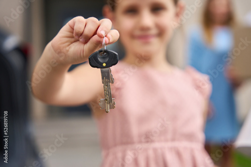 Portrait of pretty girl who shows keys to new house