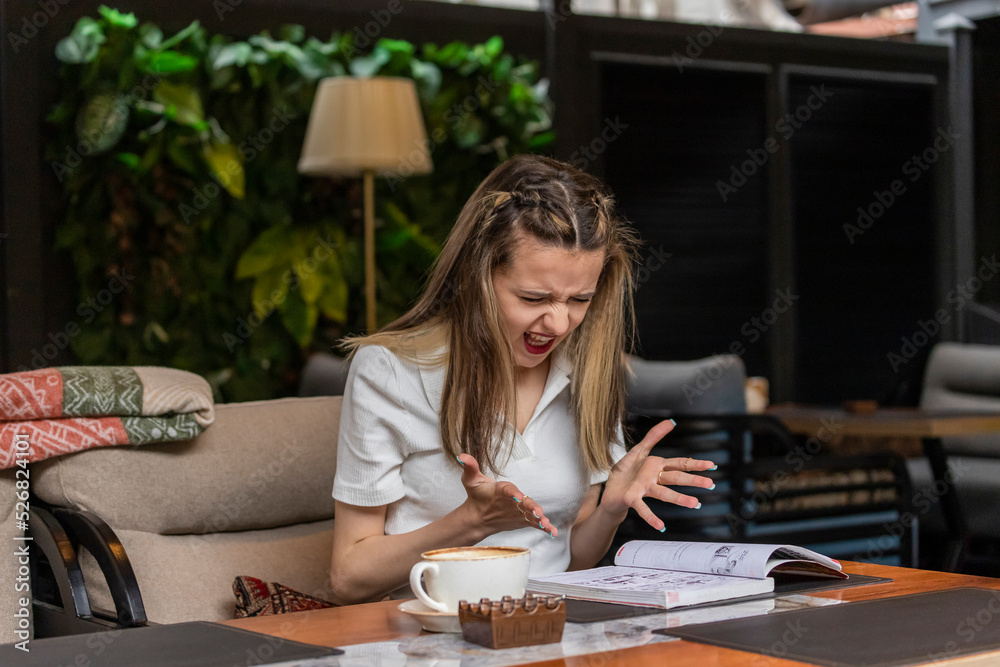 Fototapeta premium Angry lady looking at her book and screaming