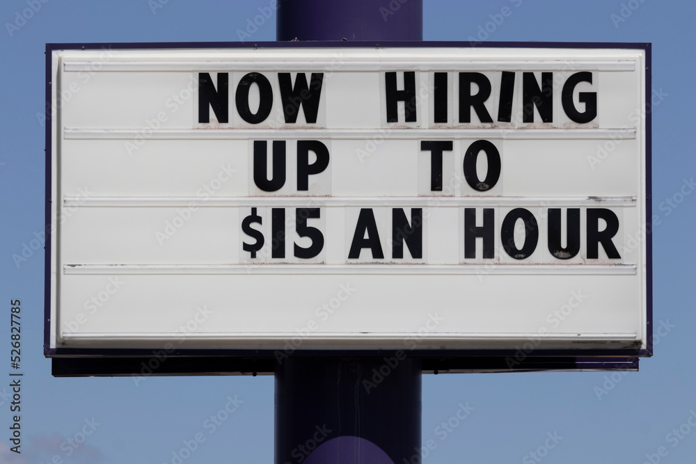 Now Hiring Up to $15 an hour sign. Amid a shortage of workers, companies, businesses and restaurants are increasing wages to attract applicants.