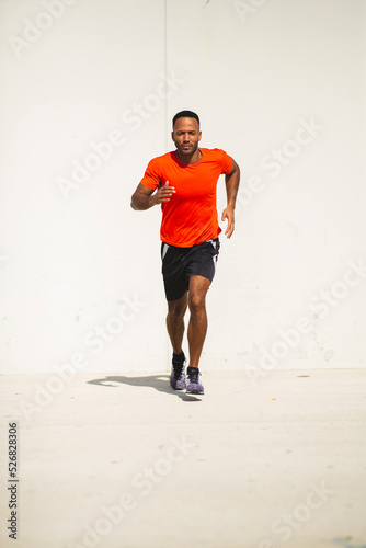 Male athlete jogging outdoors in city