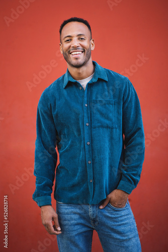 Cheerful african american man posing over maroon background