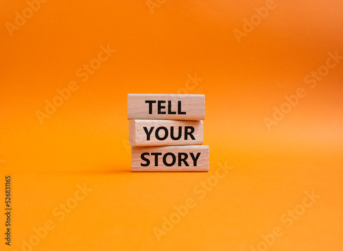 Tell your story symbol. Wooden blocks with words Tell your story. Beautiful orange background. Business and Tell your story concept. Copy space.