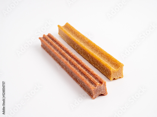 Close up dog tooth stick to reduce tartar buildup isolated on white.