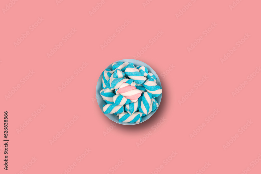 One pot with blue marshmallows on a pink background One pot with blue marshmallows on a pink background