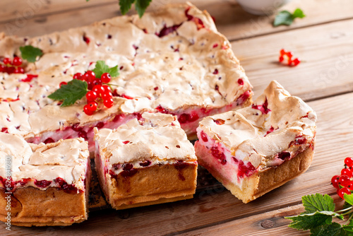 Redcurrant cheesecake, tart with fresh berries on wooden table