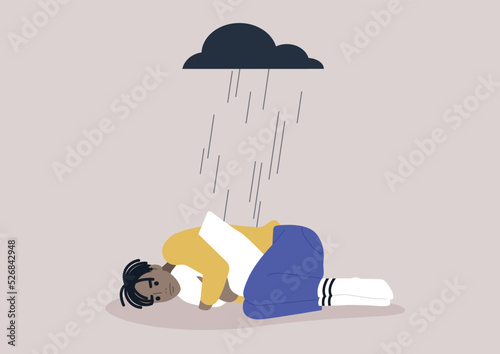 A young upset African character squeezing a pillow, a black rain cloud hovering above them