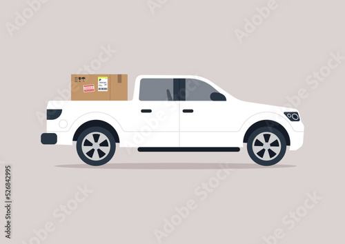 A side view of a big pick up truck loaded with a cardboard box, a cargo transportation concept