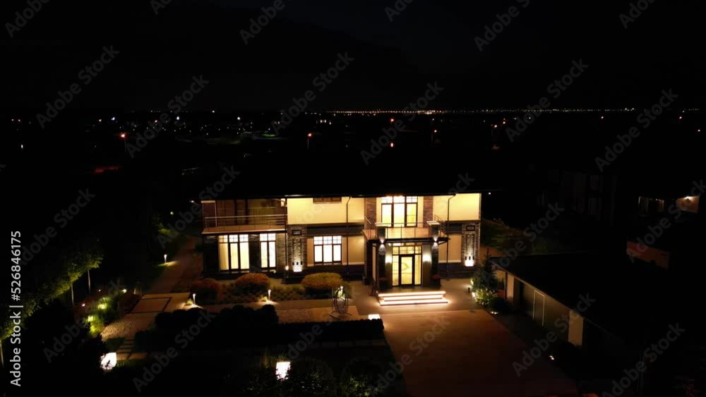 Night illumination of a country house from a drone