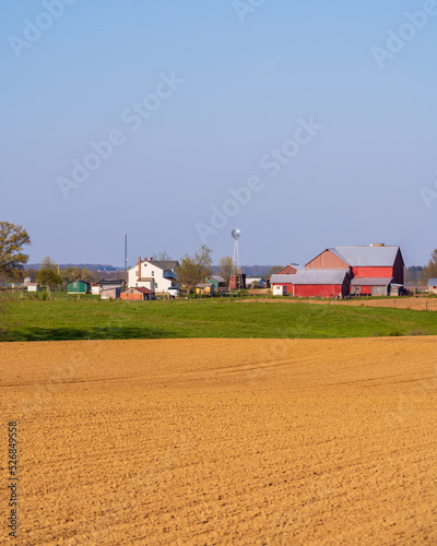 Amish farm with a freshly planted field on a sunny spring day in Amish country, Ohio