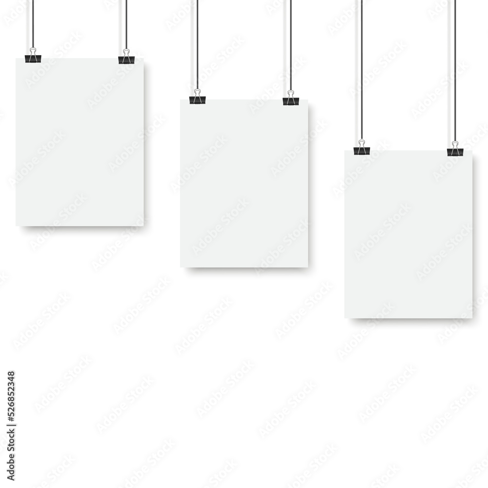 Blank posters hanging on a binder clips. A4 white paper sheet hangs on a rope with clips Blank posters hanging on a binder clips. A4 white paper sheet hangs on a rope with clips