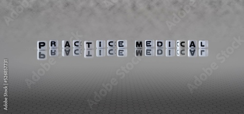 practice medical word or concept represented by black and white letter cubes on a grey horizon background stretching to infinity