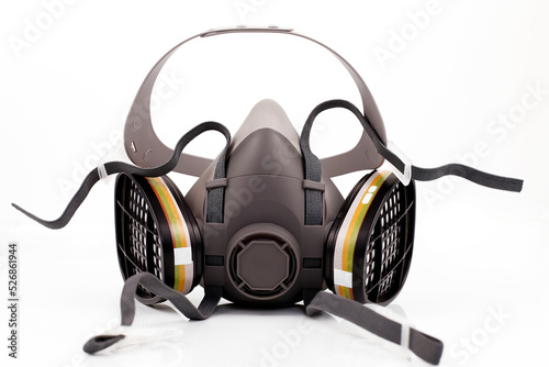 Reusable half-face elastomeric respirator for air purification with replaceable filters on a white background
