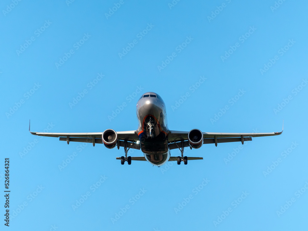MOSCOW , RUSSIA, June 10, 2019: The Commercial passenger airplane flying overhead on sunny day on June 10, 2019 in Moscow, Russia MOSCOW , RUSSIA, June 10, 2019: The Commercial passenger airplane flying overhead on sunny day on June 10, 2019 in Moscow, Russia