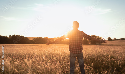 Person man in the field enjoying nature and the warm sunshine.  © kieferpix