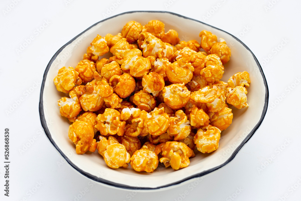 Honey caramel popcorn on white background. Honey caramel popcorn on white background.