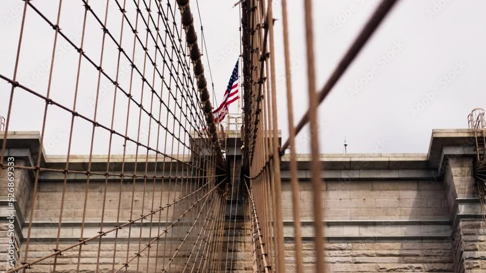 Close-up of Brooklyn Bridge Towers with American National Flag on the Top Close-up of Brooklyn Bridge Towers with American National Flag on the Top