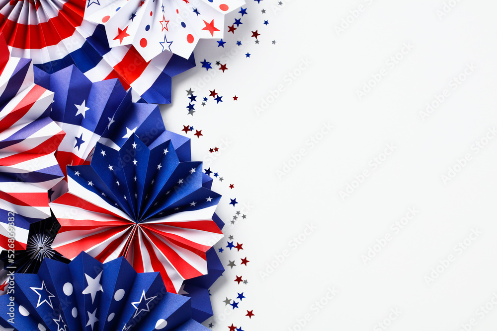 Obraz premium USA paper fans and confetti on white desk table, top view. Happy Labor Day, Independence Day, Presidents Day banner mockup