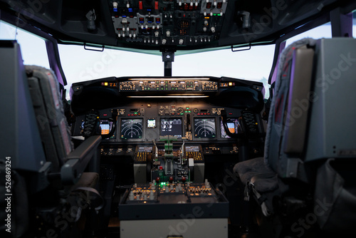 Nobody in airplane cabin with dashboard command and control panel, used to fly aircraft jet with power engine and buttons or lever. Radar navigation compass with electronic switch board.