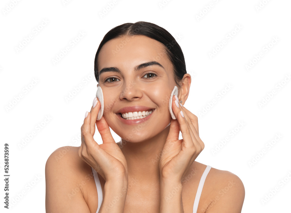 Young woman using cotton pads with micellar water on white background