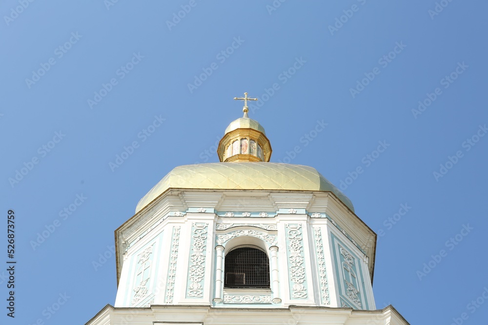 Beautiful church with golden dome against blue sky, low angle view Beautiful church with golden dome against blue sky, low angle view