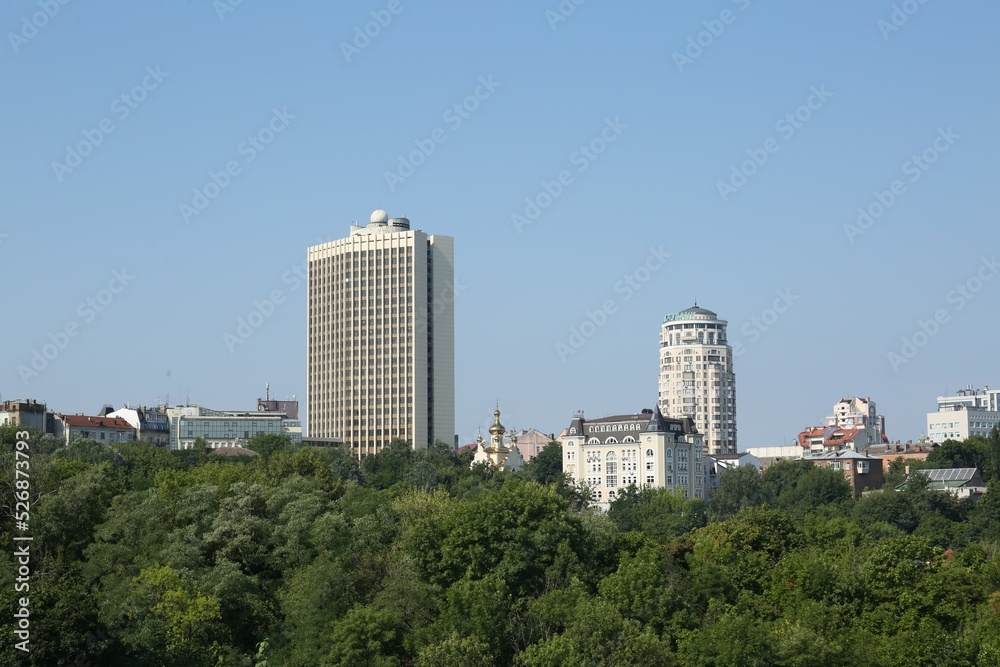 View of beautiful city with buildings and trees on sunny day