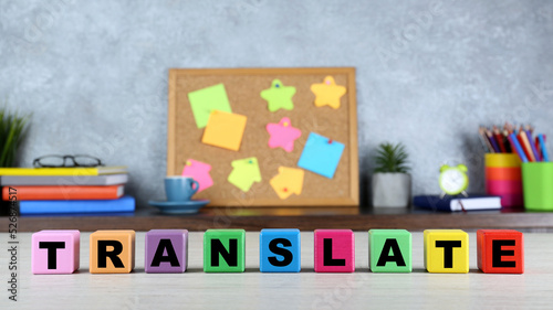 Word Translate made of colorful cubes with letters on white wooden table