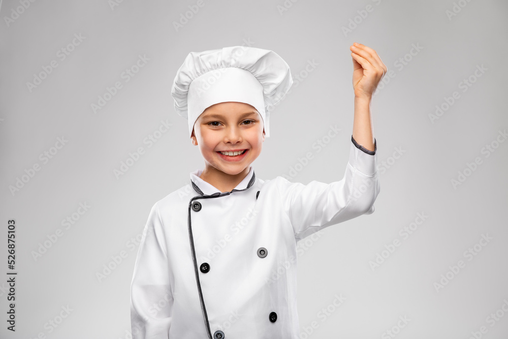 cooking, culinary and profession concept - happy smiling little boy in chef's toque and jacket over grey background cooking, culinary and profession concept - happy smiling little boy in chef's toque and jacket over grey background
