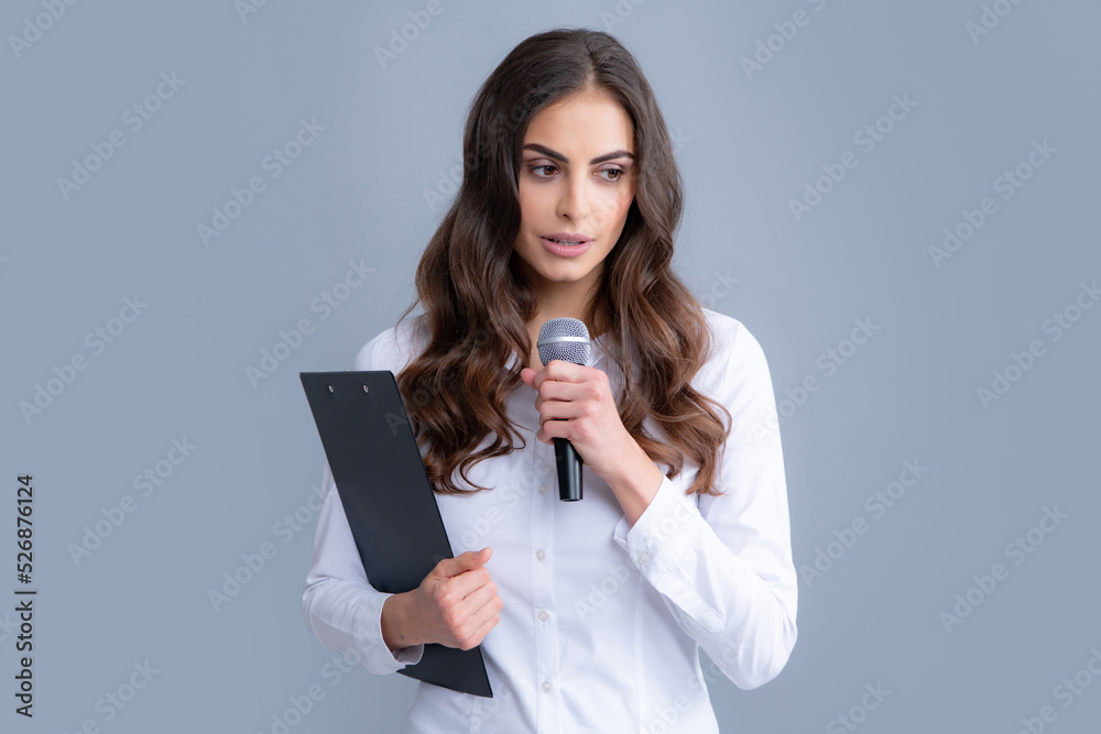 Beautiful business woman is speaking on conference. Microphone speech speaking concept. Young beautiful woman singing song using microphone.