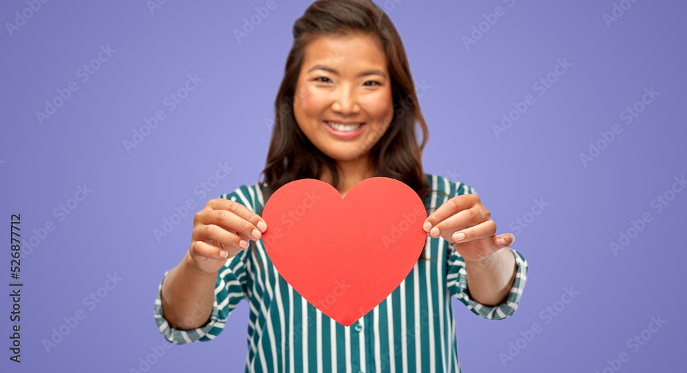love, charity and valentine's day concept - happy woman with red heart over violet background love, charity and valentine's day concept - happy woman with red heart over violet background