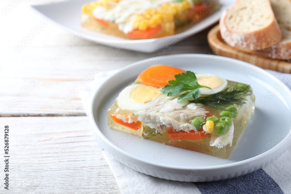 Delicious fish aspic served on white wooden table Delicious fish aspic served on white wooden table