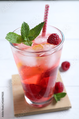 Delicious raspberry lemonade made with soda water on white wooden table