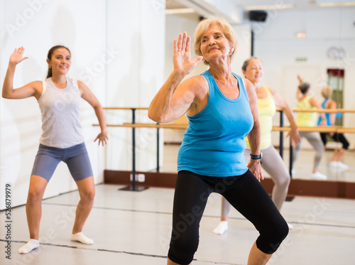 Active mature women enjoying training in dance studio, dance class for adults