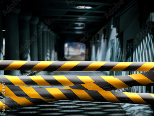 black and yellow safety tape outdoors in the street, restricted area