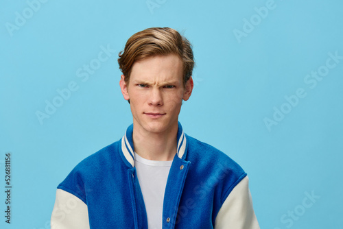 Photographie portrait of a gloomy guy in a blue bomber jacket