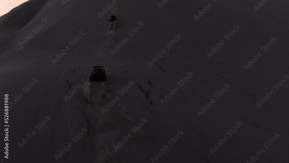 Offroad Dune Buggy driving in the desert Sand Dunes at dusk