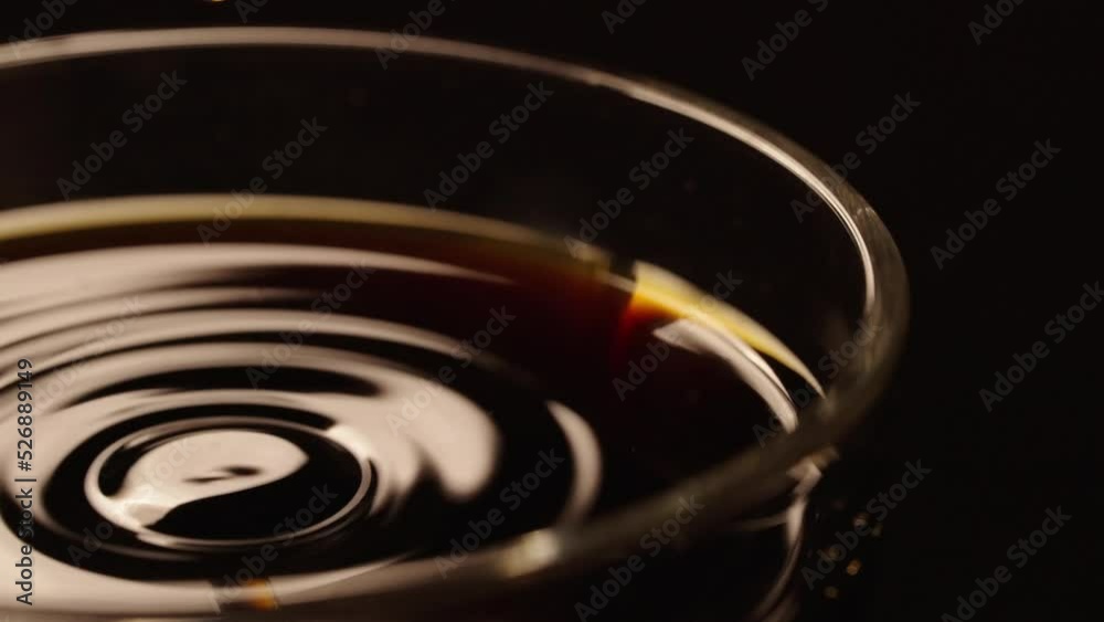 Water droplets falling into a cup with splashes slow motion close-up Water droplets falling into a cup with splashes slow motion close-up