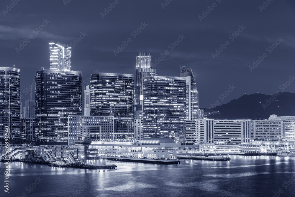 High rise office building and pier in Hong Kong city at night