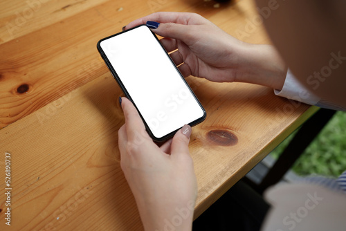 Asian person hand holding smartphone empty screen. Technology concept