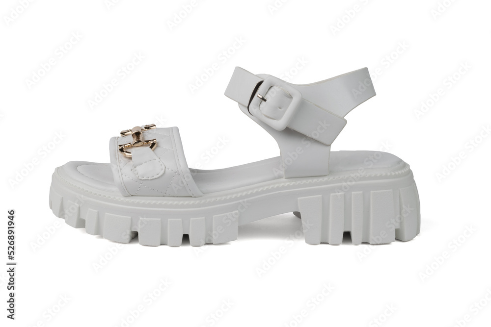 White leather sandal with gold trim isolated on a white background. White leather sandal with gold trim isolated on a white background.