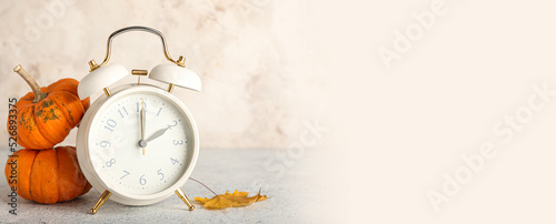 Alarm clock and autumn leav...