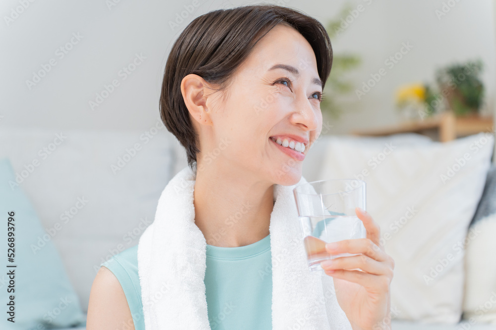 水を持ったヨガウェアの日本人女性